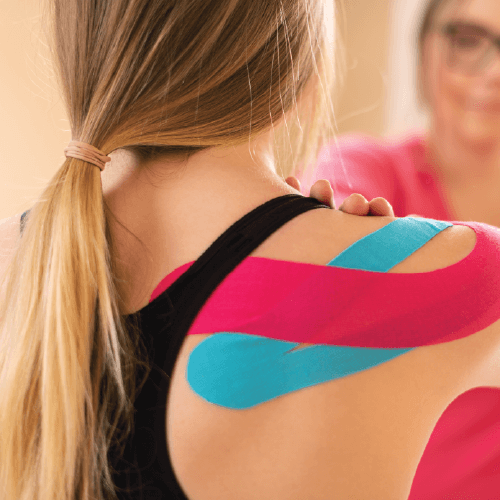 Female patient with kinesio tape on her right shoulder.